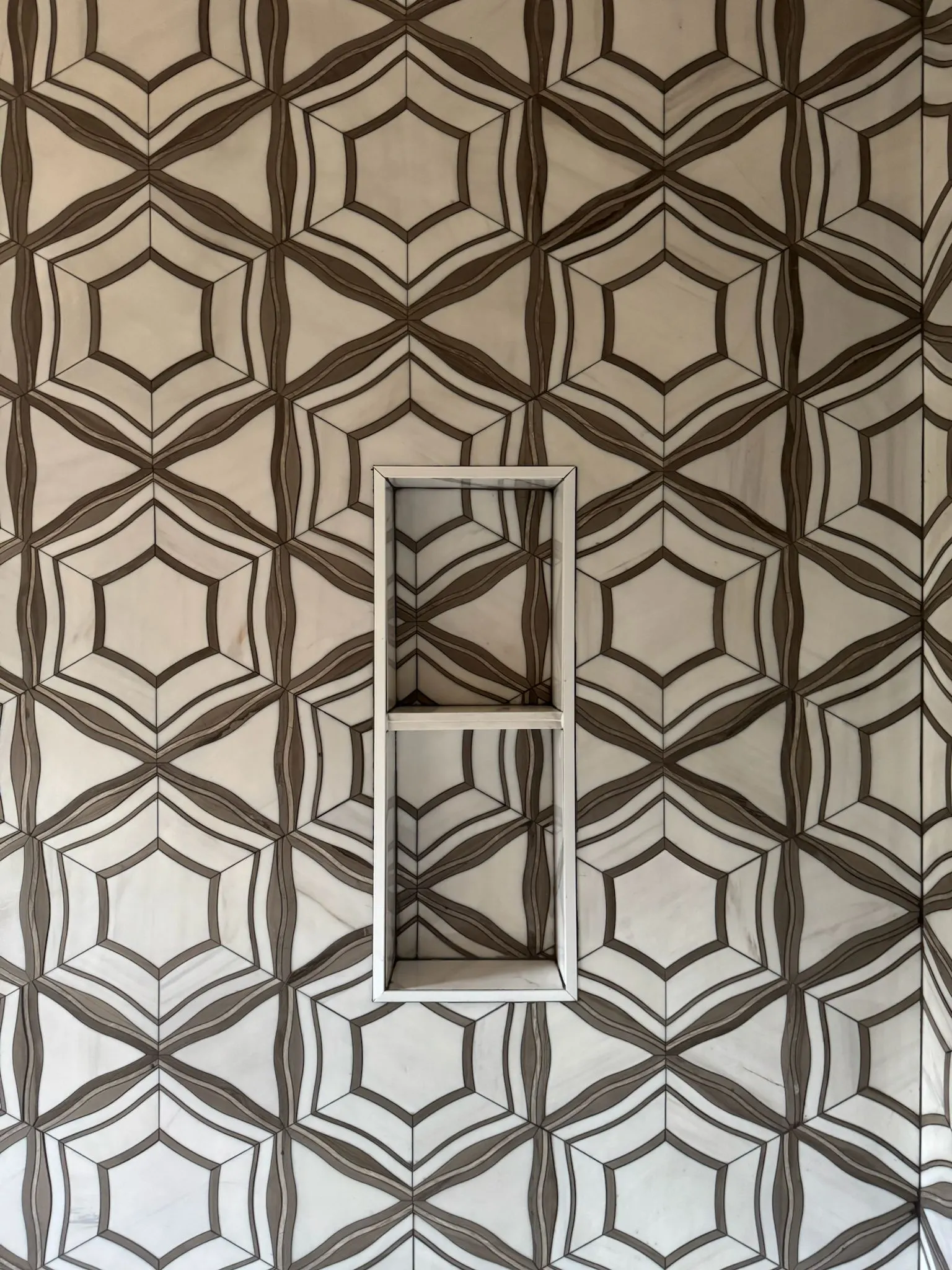 White and walnut marble star and hexagon feature wall with niche