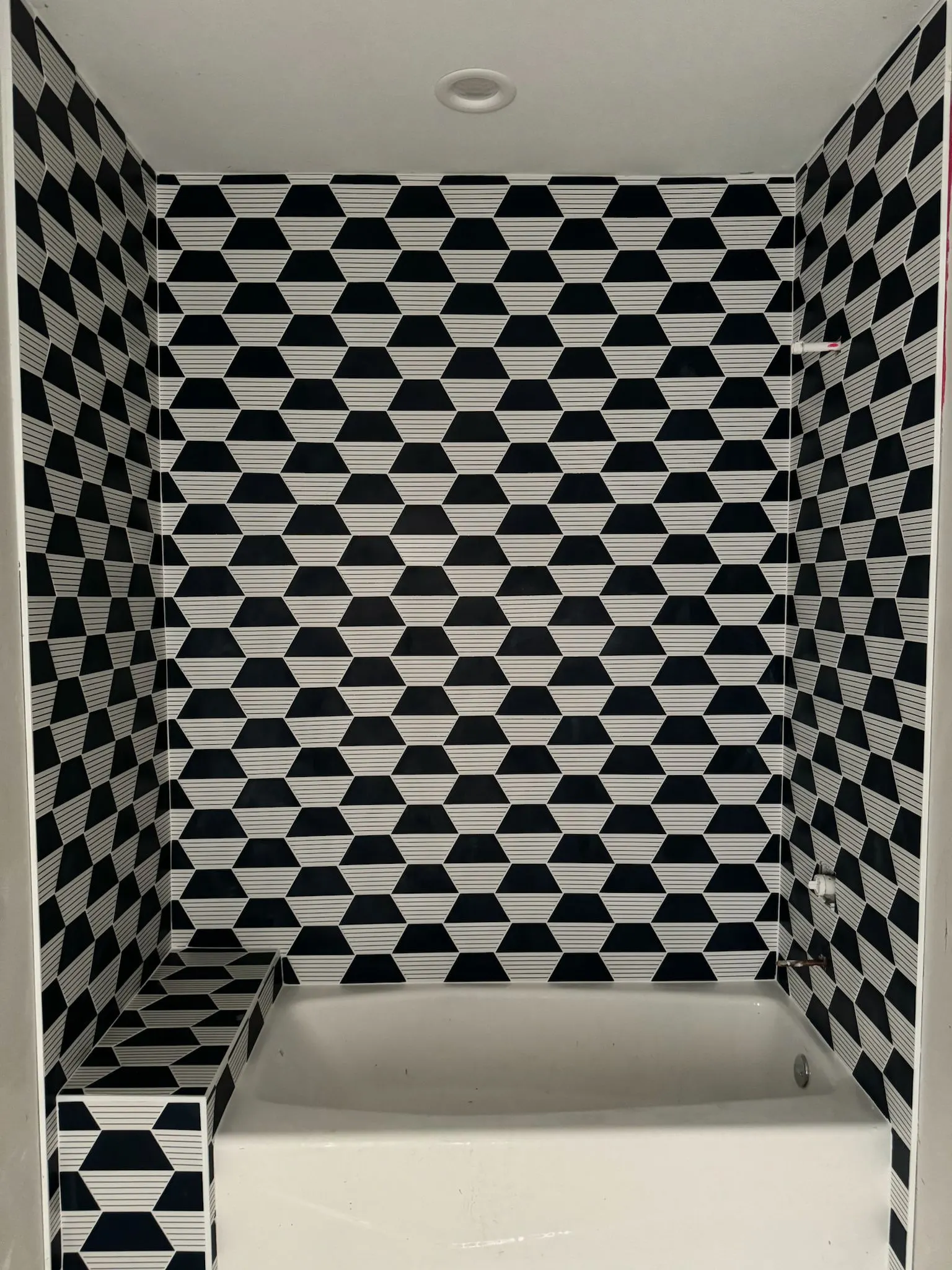 Navy and white geometric tile shower and backsplash