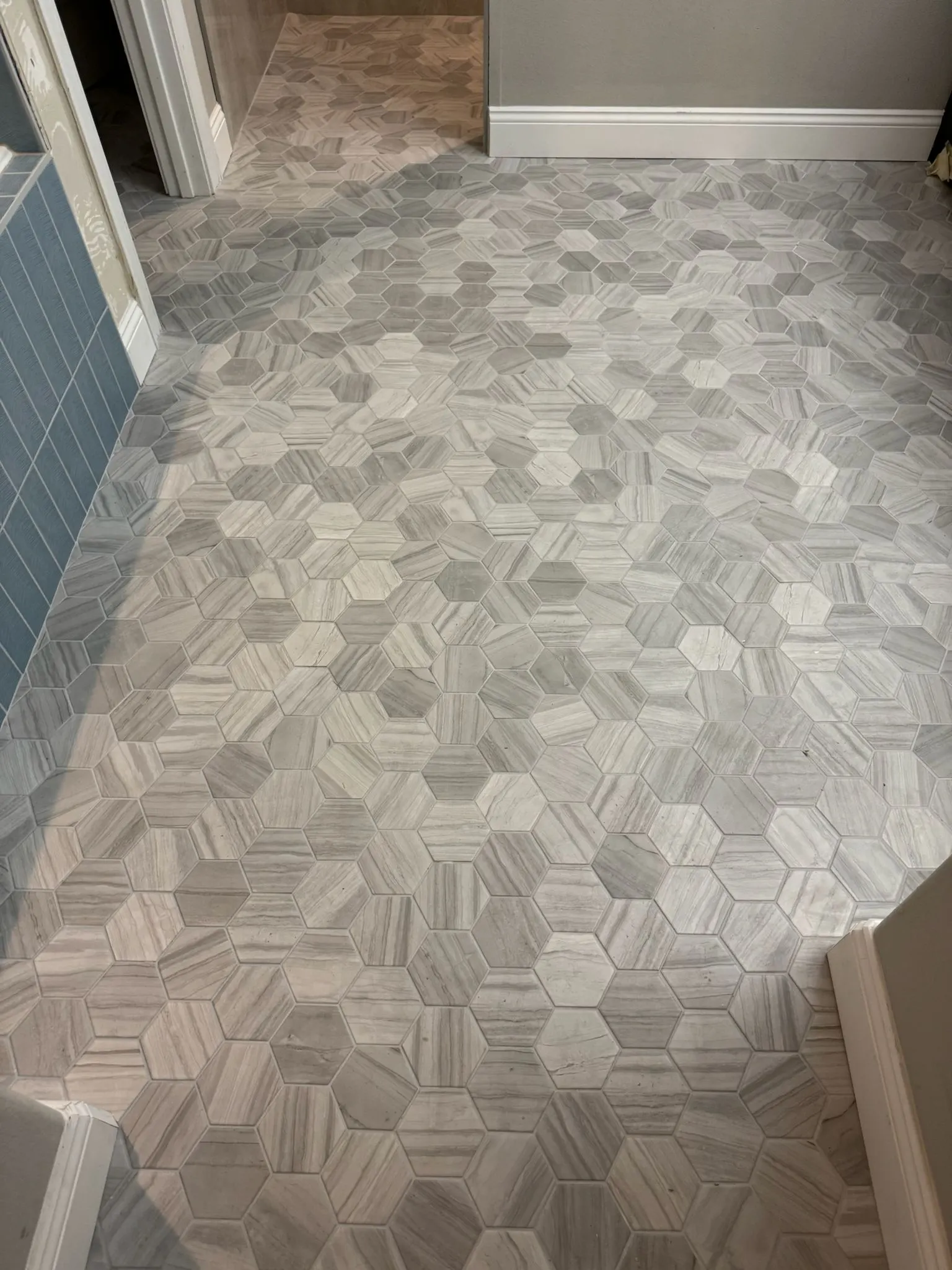 Grey hexagon marble tile floor installation